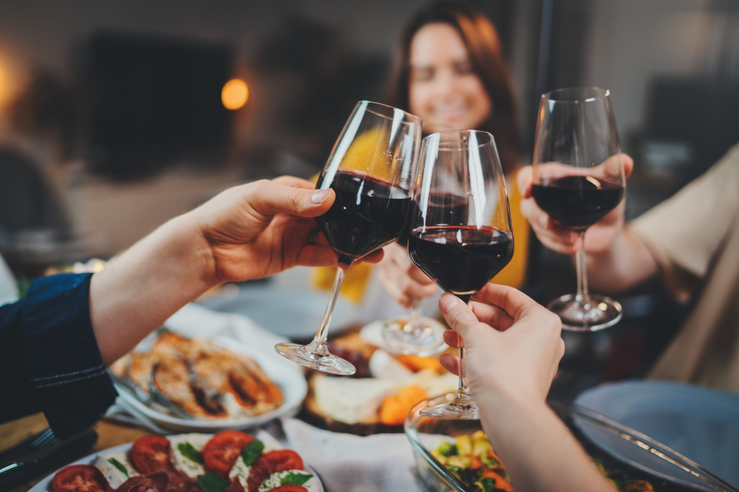 Group of people celebrating anniversary at home, cozy atmosphere, family dining at restaurant with healthy food making cheers with wine glasses, Togetherness Friendship Traditional concept